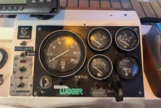Slide: The Image of Control panel of a 1983 Nordic Tug 26 boat with gauges and switches. - 22