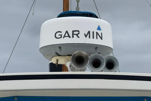 Slide: The Image of Garmin radar on 1983 Nordic Tug 26 boat against cloudy sky. - 3