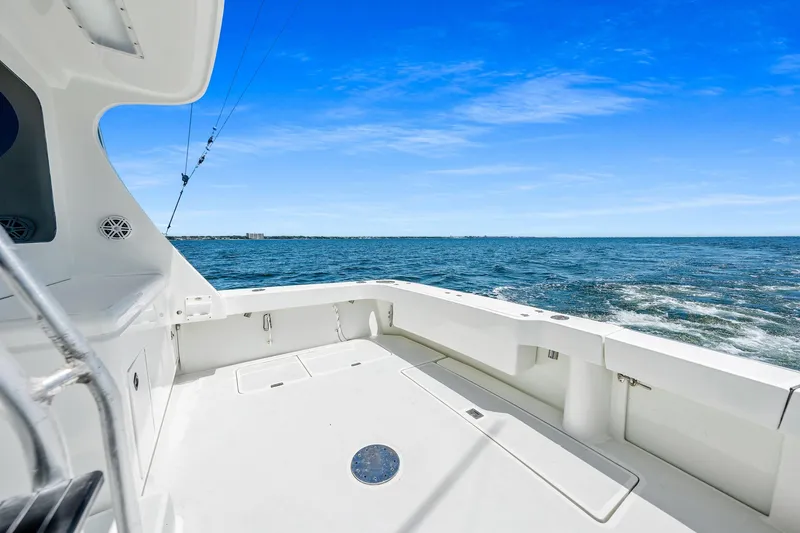 Slide: The Image of 1994 Luhrs 38 Convertible boat deck with ocean view under clear blue sky. - 10