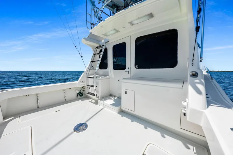 Slide: The Image of 1994 Luhrs 38 Convertible yacht deck with ocean view and ladder. - 11