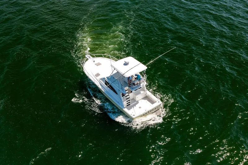 Slide: The Image of Aerial view of 1994 Luhrs 38 Convertible boat cruising on open water. - 14