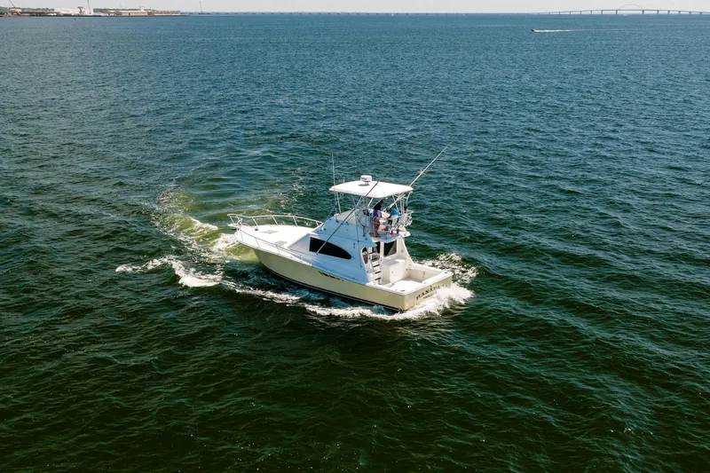 Slide: The Image of 1994 Luhrs 38 Convertible boat cruising on open water. - 15