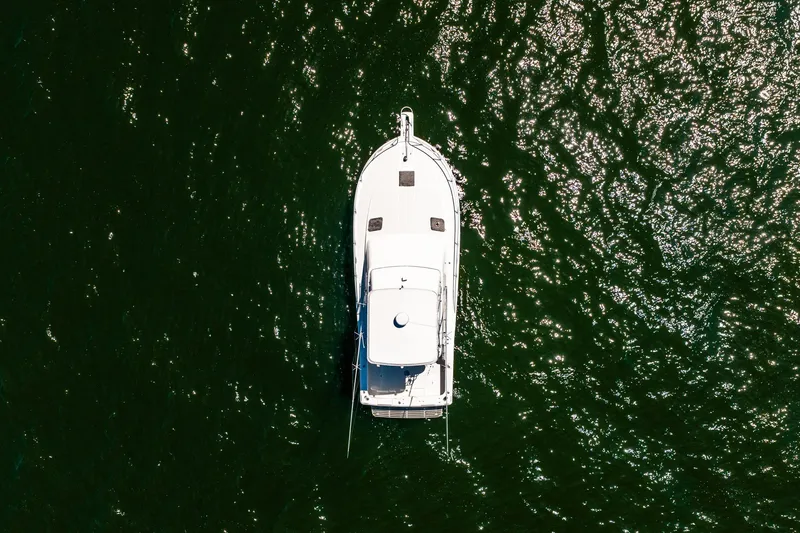 Slide: The Image of Aerial view of 1994 Luhrs 38 Convertible boat on shimmering water. - 22