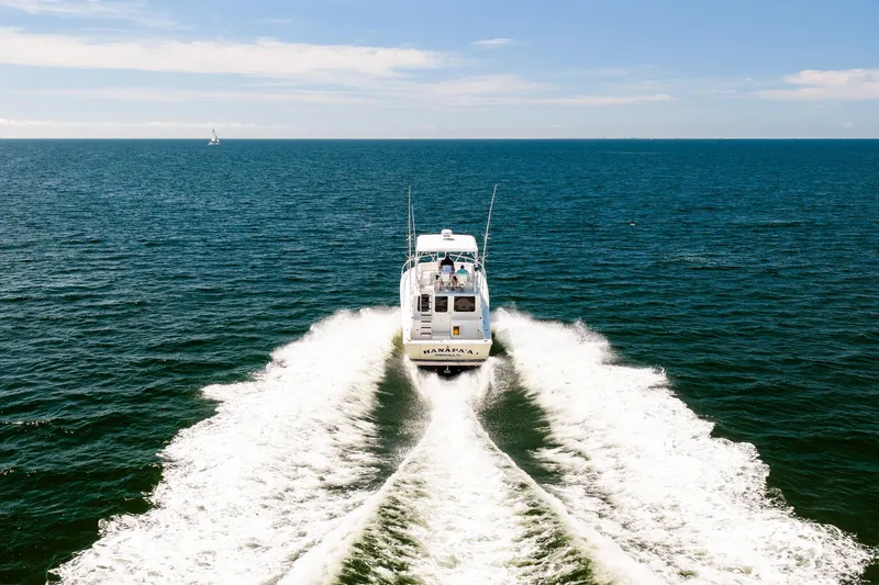 Slide: The Image of 1994 Luhrs 38 Convertible cruising on open ocean, leaving a wake behind. - 29
