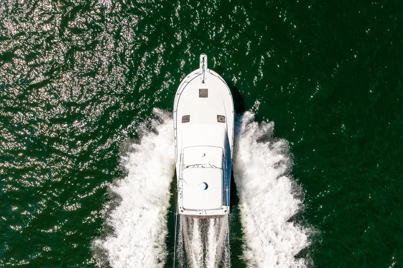 Slide: The Image of Aerial view of 1994 Luhrs 38 Convertible yacht cruising on green water. - 31