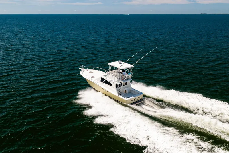 Slide: The Image of 1994 Luhrs 38 Convertible yacht cruising on open sea. - 32