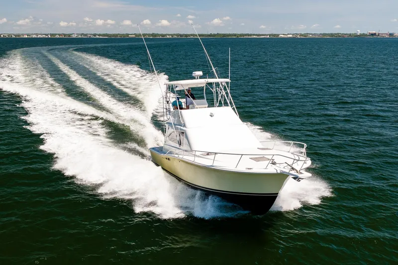 Slide: The Image of 1994 Luhrs 38 Convertible yacht cruising on open water. - 35
