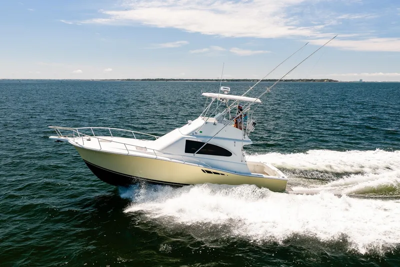 Slide: The Image of 1994 Luhrs 38 Convertible yacht cruising on open water. - 45