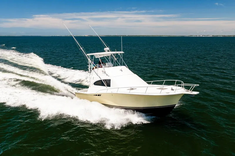 Slide: The Image of 1994 Luhrs 38 Convertible yacht cruising on open water. - 48