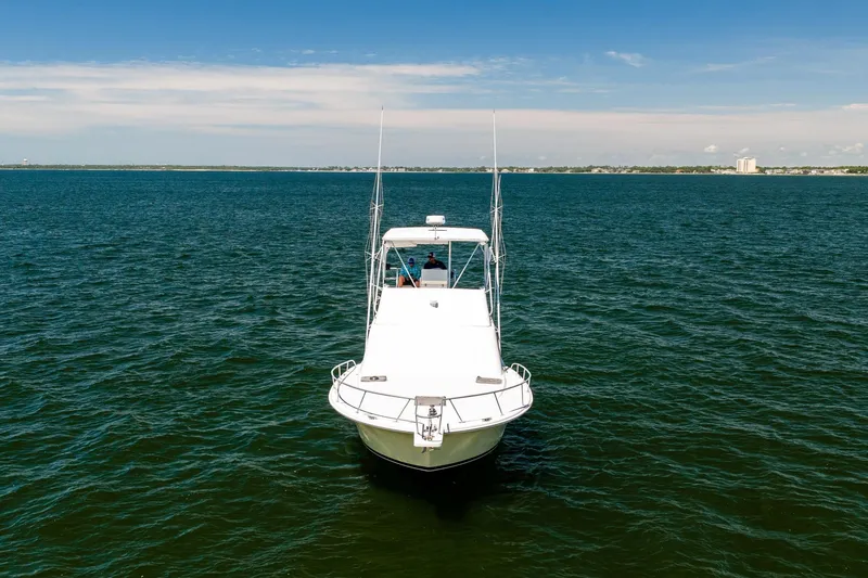 Slide: The Image of 1994 Luhrs 38 Convertible boat on open water under clear blue sky. - 5