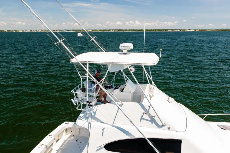 Slide: The Image of 1994 Luhrs 38 Convertible yacht cruising on open water under clear skies. - 50