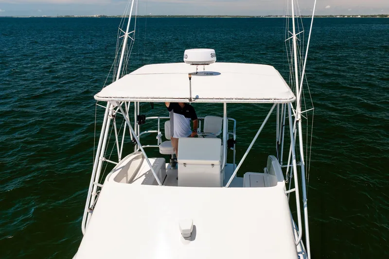 Slide: The Image of 1994 Luhrs 38 Convertible boat cruising on open water, viewed from above. - 51
