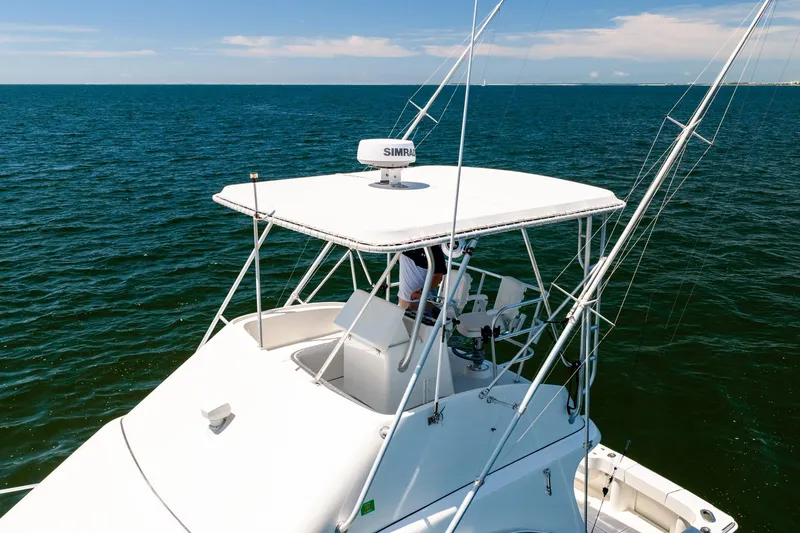 Slide: The Image of 1994 Luhrs 38 Convertible yacht on open sea, featuring a white helm station. - 52
