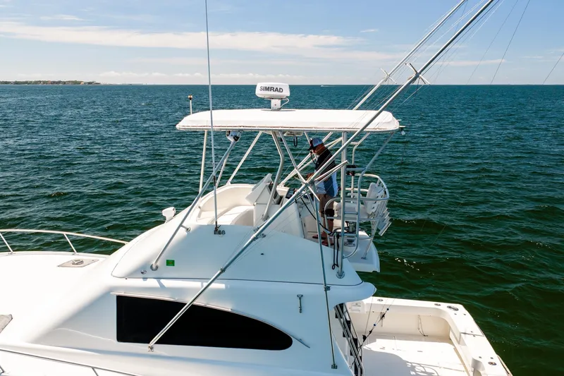 Slide: The Image of 1994 Luhrs 38 Convertible yacht cruising on open water. - 53