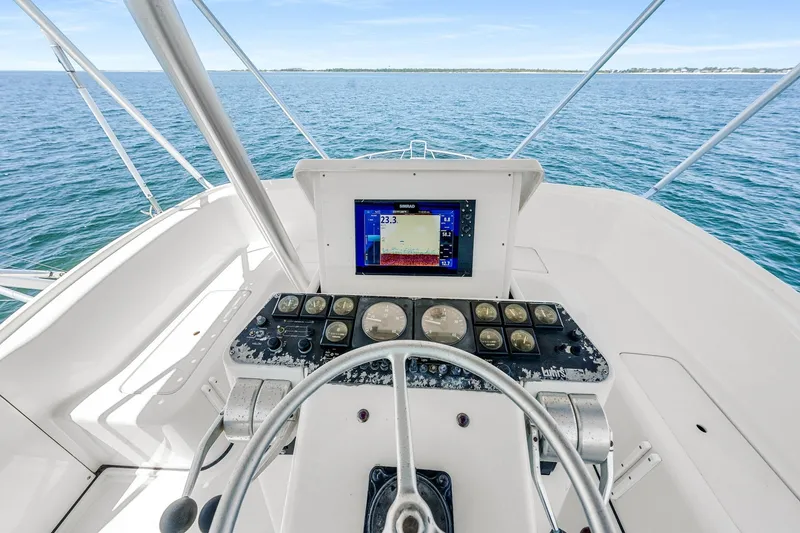 Slide: The Image of Helm of 1994 Luhrs 38 Convertible boat with navigation instruments and ocean view. - 63