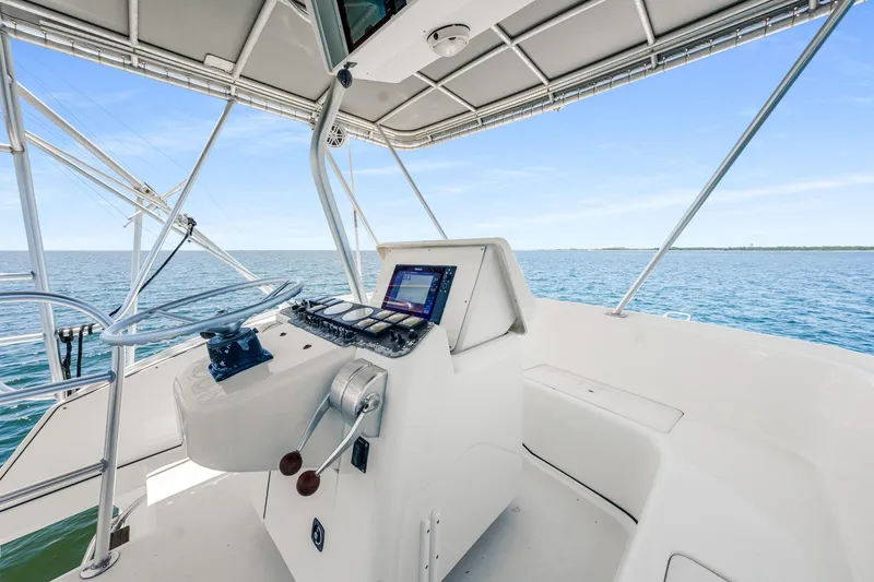 Slide: The Image of Helm of 1994 Luhrs 38 Convertible yacht with ocean view. - 65