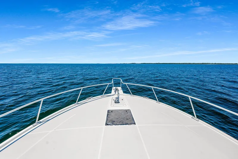 Slide: The Image of Bow view of 1994 Luhrs 38 Convertible yacht on open water. - 69