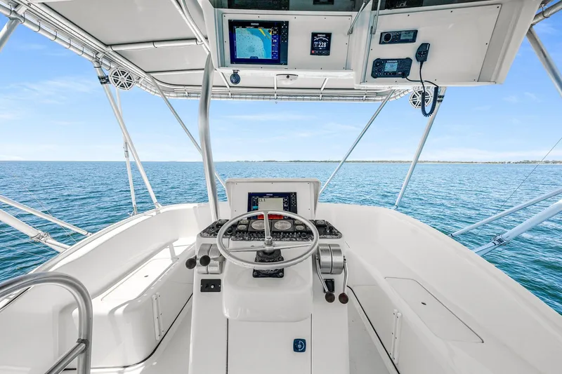 Slide: The Image of Helm of 1994 Luhrs 38 Convertible yacht with ocean view and navigation equipment. - 7