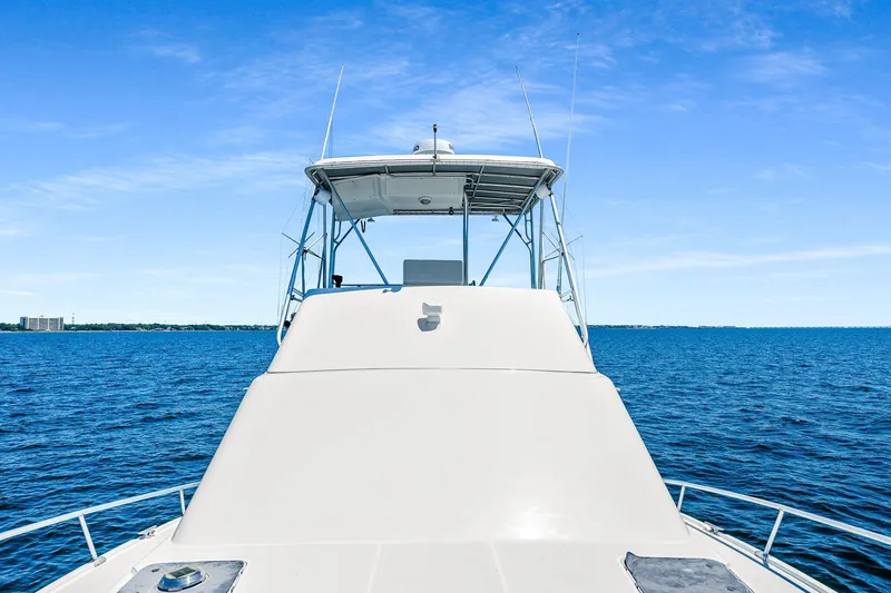 Slide: The Image of 1994 Luhrs 38 Convertible yacht on open water under clear blue sky. - 71