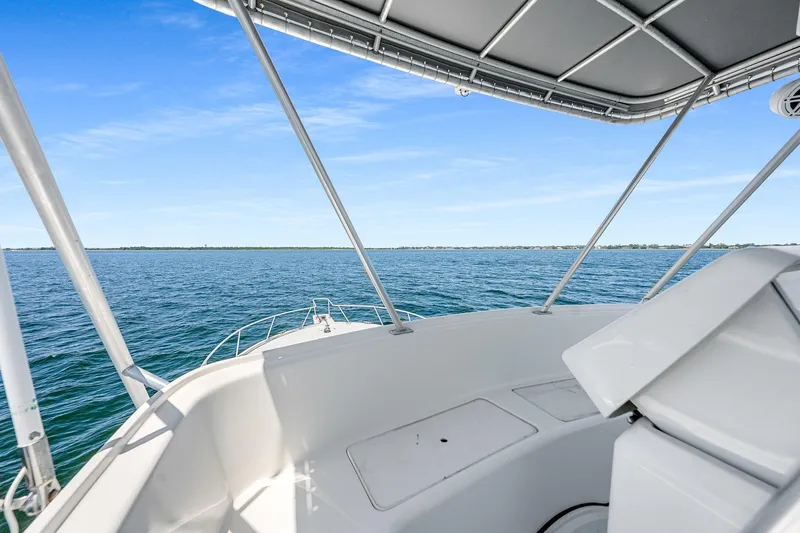 Slide: The Image of 1994 Luhrs 38 Convertible boat deck with ocean view under clear blue sky. - 76
