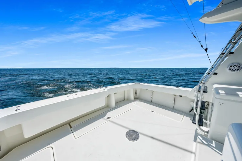 Slide: The Image of 1994 Luhrs 38 Convertible boat deck with ocean view under clear blue sky. - 77