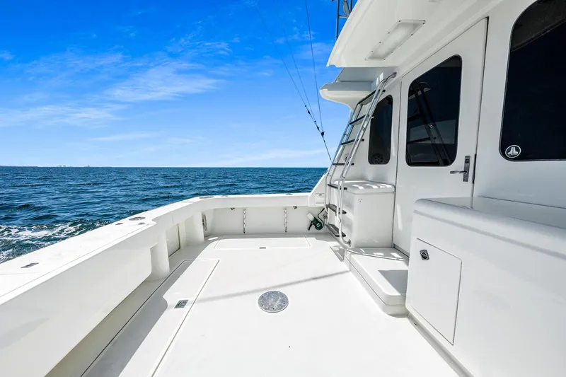 Slide: The Image of 1994 Luhrs 38 Convertible yacht deck with ocean view under clear blue sky. - 78