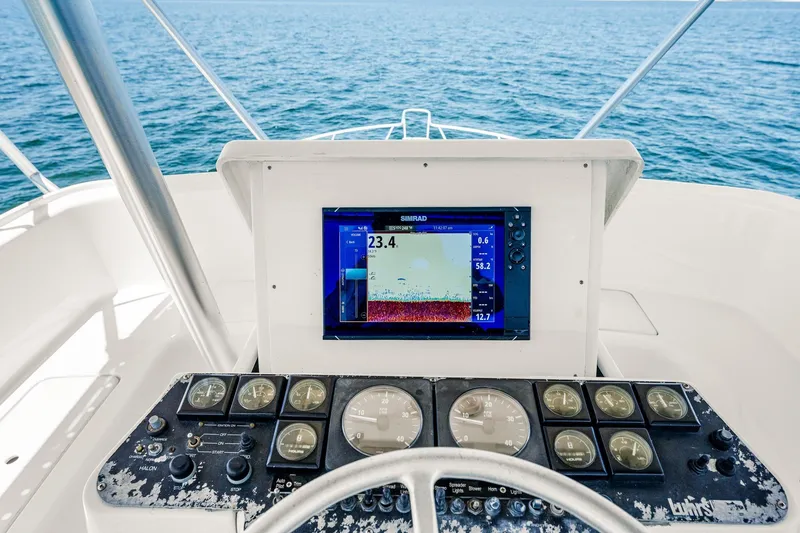 Slide: The Image of Helm of 1994 Luhrs 38 Convertible with navigation display and gauges, overlooking the ocean. - 9
