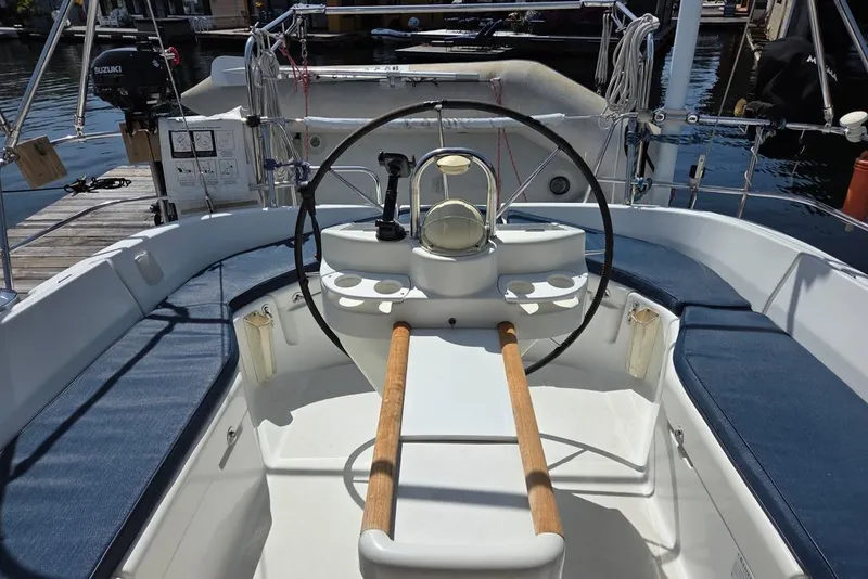 Slide: The Image of Cockpit of a 2000 Beneteau Oceanis 411 sailboat with steering wheel and seating - 13