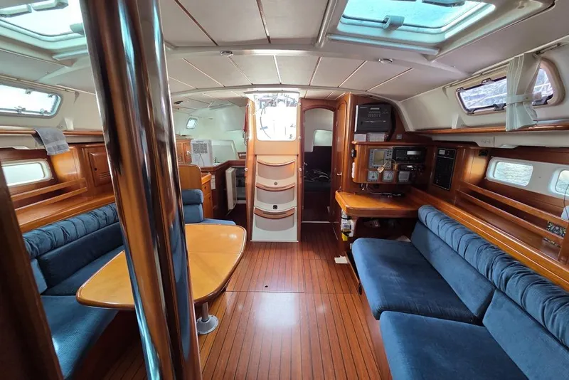 Slide: The Image of Interior of a 2000 Beneteau Oceanis 411 sailboat with cherry wood finish and blue upholstery - 2