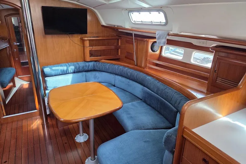 Slide: The Image of Interior of 2000 Beneteau Oceanis 411 yacht with blue cushions and table - 20