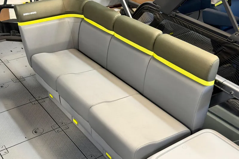 Slide: The Image of 2026 Sea-Doo Switch Fish 21 interior seating with gray and yellow accents. - 17