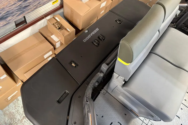 Slide: The Image of 2026 Sea-Doo Switch Fish 21 interior with storage boxes and seating. - 25