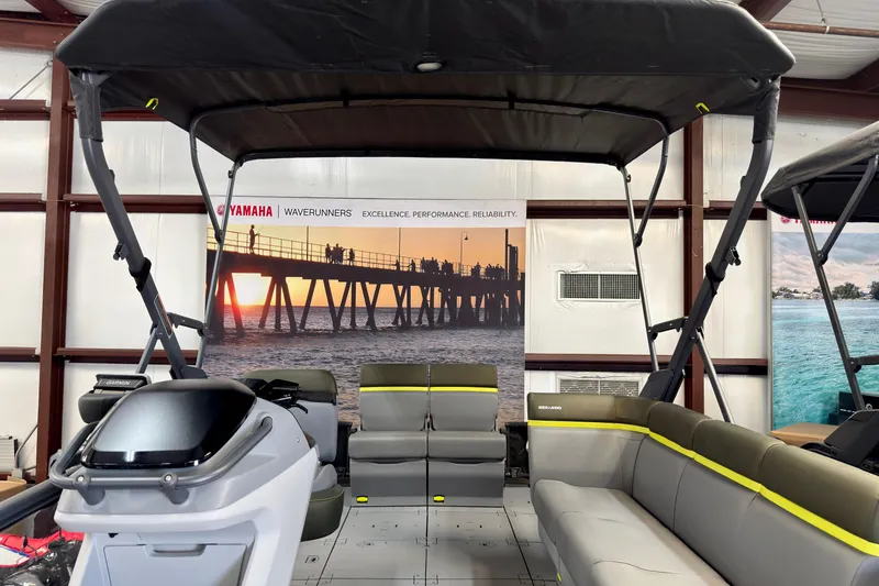 Slide: The Image of 2026 Sea-Doo Switch Fish 21 boat interior with seating and canopy in showroom. - 27
