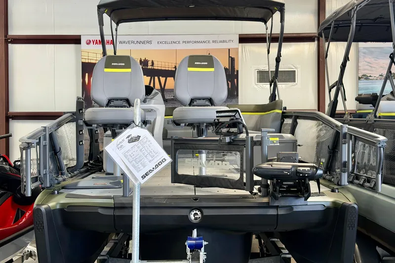 Slide: The Image of 2026 Sea-Doo Switch Fish 21 pontoon boat displayed indoors with seating and equipment. - 9