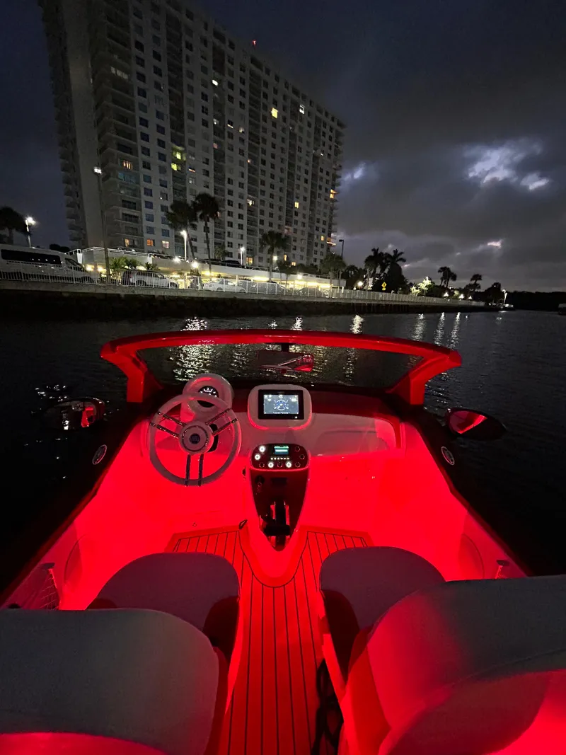 Slide: The Image of Fiat 500 Classic boat interior with red lighting, cityscape in background, 2025 model. - 18
