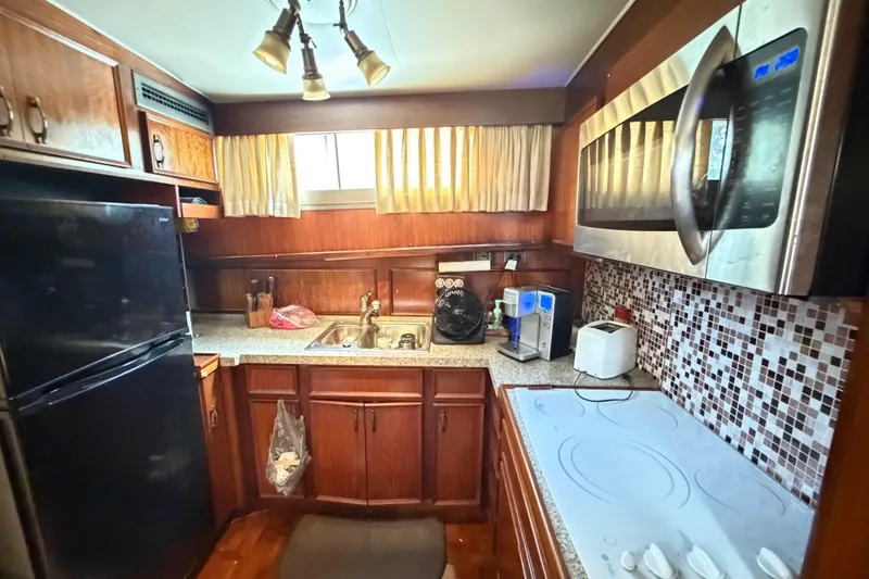 Slide: The Image of 1978 Hatteras 53 Motor Yacht kitchen with modern appliances and wood cabinetry. - 10