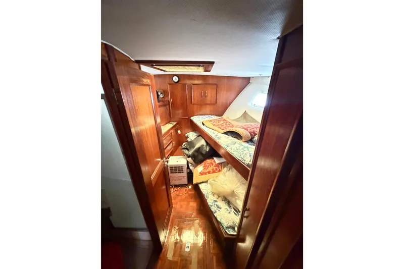 Slide: The Image of 1978 Hatteras 53 Motor Yacht cabin with wooden interior and bunk beds. - 11