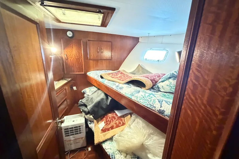 Slide: The Image of 1978 Hatteras 53 Motor Yacht cabin with wooden interior and bunk beds. - 13