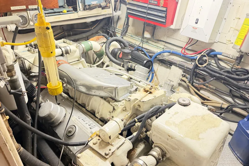 Slide: The Image of Engine room of a 1978 Hatteras 53 Motor Yacht with visible machinery and wiring. - 14