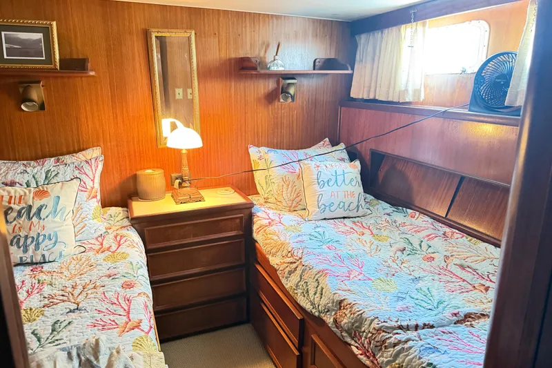 Slide: The Image of Cozy cabin interior of 1978 Hatteras 53 Motor Yacht with twin beds and nautical decor. - 16