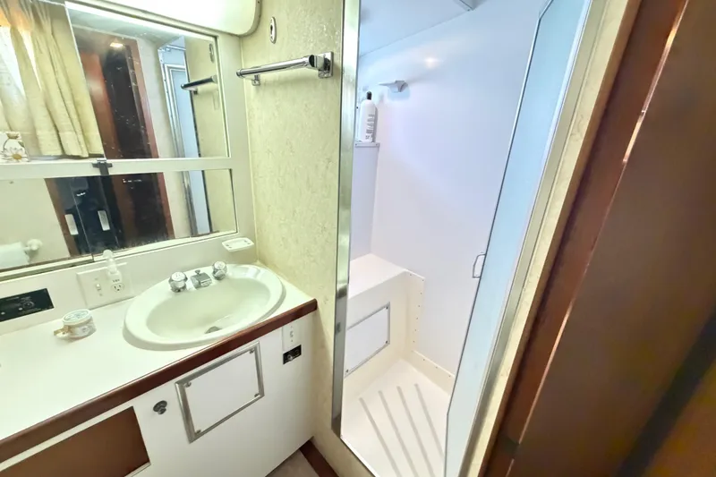 Slide: The Image of 1978 Hatteras 53 Motor Yacht bathroom with sink, mirror, and shower. - 18