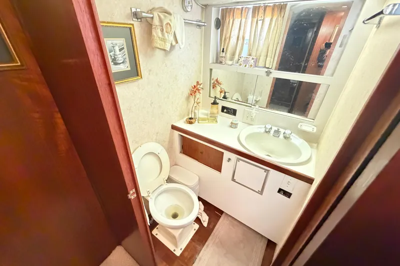 Slide: The Image of 1978 Hatteras 53 Motor Yacht bathroom with sink, toilet, and mirror. - 19