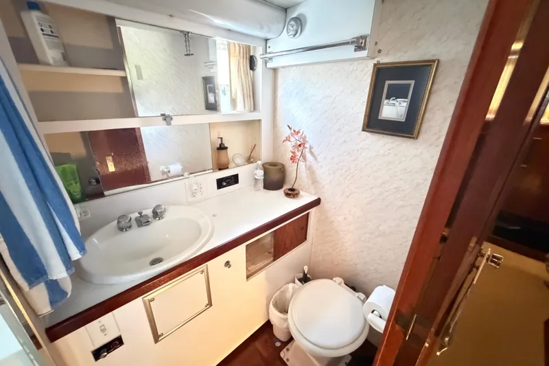 Slide: The Image of 1978 Hatteras 53 Motor Yacht bathroom with sink, mirror, and toilet. - 20
