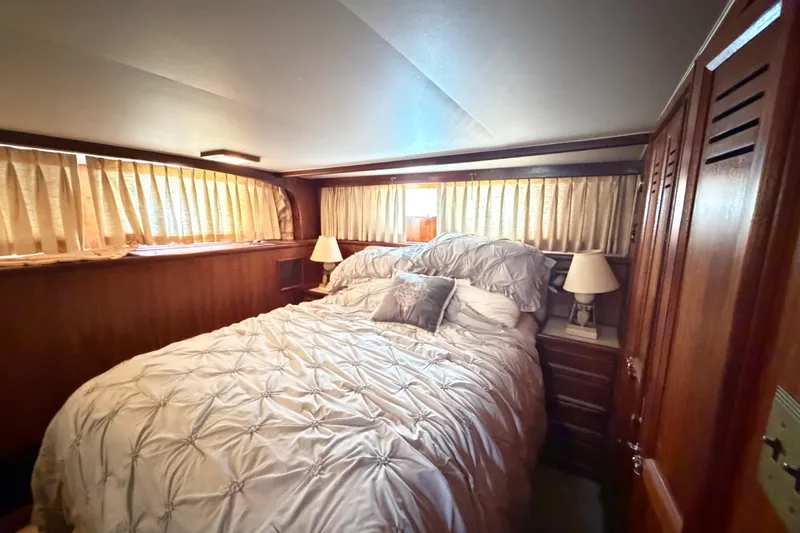 Slide: The Image of Luxurious bedroom interior of a 1978 Hatteras 53 Motor Yacht with elegant bedding. - 22