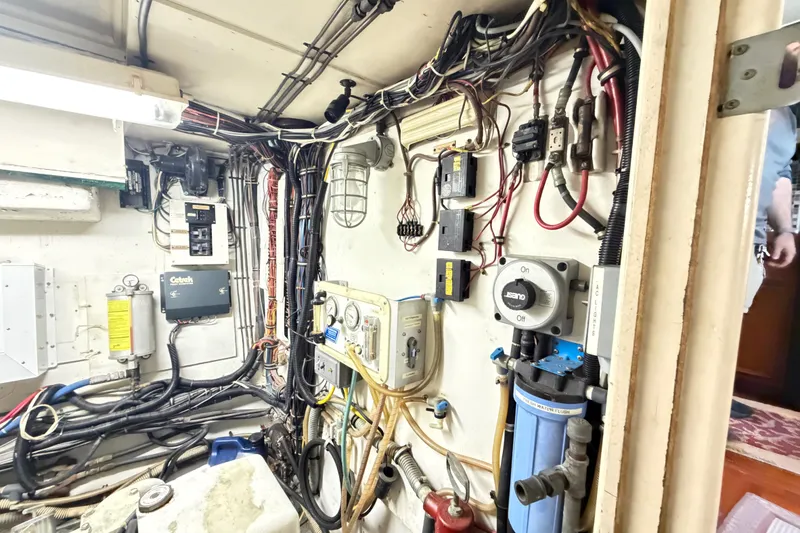 Slide: The Image of Electrical and mechanical systems inside a 1978 Hatteras 53 Motor Yacht engine room. - 24