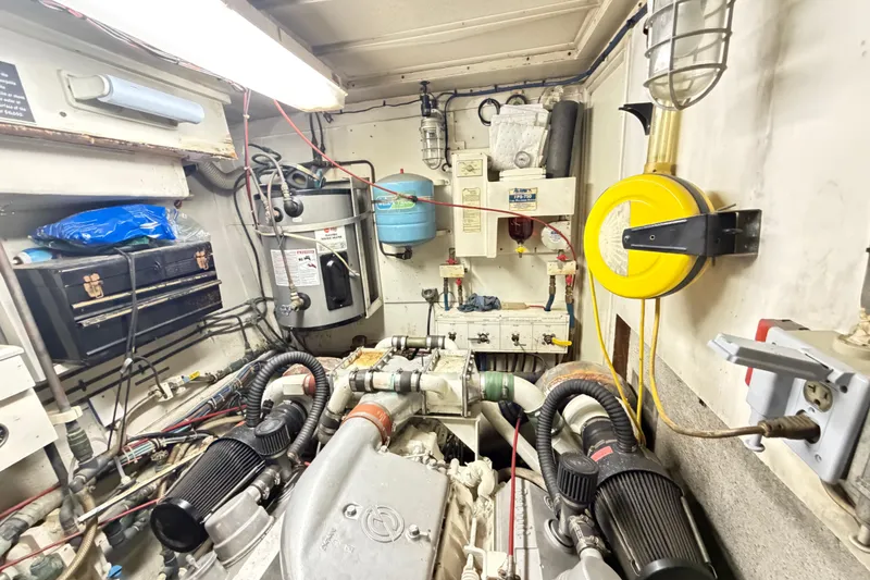Slide: The Image of Engine room of a 1978 Hatteras 53 Motor Yacht with mechanical equipment. - 26