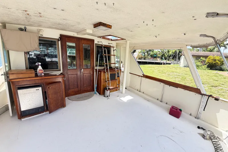 Slide: The Image of 1978 Hatteras 53 Motor Yacht interior with wooden cabinetry and open windows. - 31