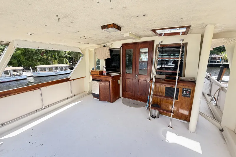 Slide: The Image of 1978 Hatteras 53 Motor Yacht interior with wooden cabinetry and river view. - 32