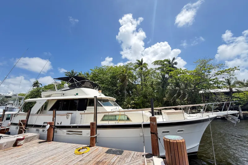 Slide: The Image of 1978 Hatteras 53 Motor Yacht docked under a clear blue sky. - 33