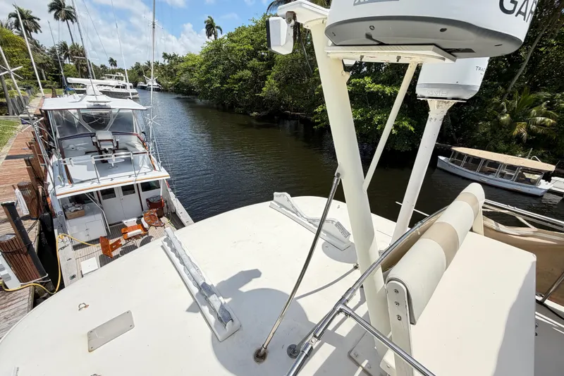 Slide: The Image of 1978 Hatteras 53 Motor Yacht docked by a lush, tree-lined waterway. - 39